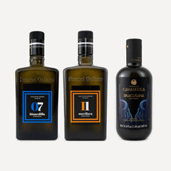 Two dark glass bottles of Frantoio Galioto and 1 Tenuta Cavasecca  olive oil arranged side by side on a light gray background. The bottles feature black caps and labels in blue, orange, and black with white and gold text.