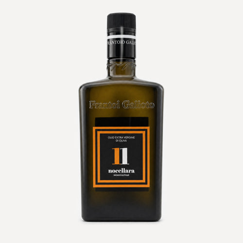A dark olive-green glass bottle of Frantoio Galioto Nocellara N*11 olive oil, featuring a black cap and a black label with orange borders and white text.