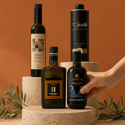 Four separate olive oil bottles on stone blocks against a terracotta background